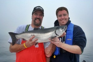 Terry and Adam Rudnick show off a late-season Coho that grabbed a plug-cut herring fished in the prop-wash about two rod-lengths behind the boat. (Terry Rudnick photo) 
